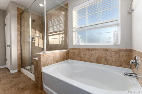 a white bath tub sitting next to a window