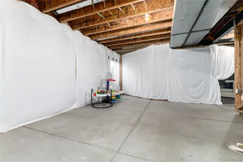 a view of storage and utility room with a window