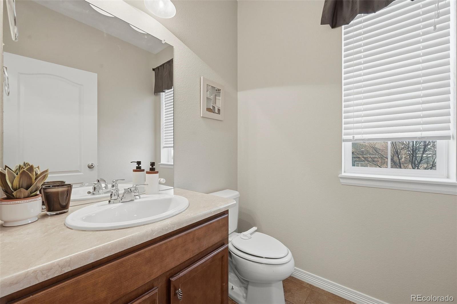 35 North Newcastle Way Aurora, CO 80018 - Photo 4 of 45 a bathroom with a sink and a toilet