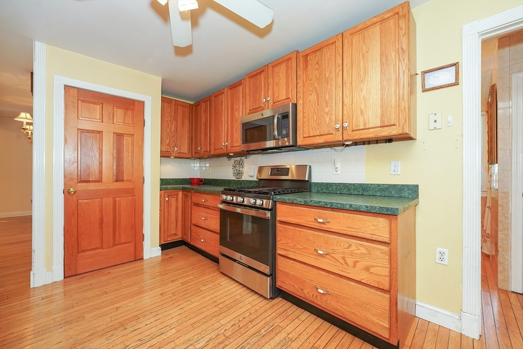 456 Gleasondale Road Stow, MA 01775 - Photo 11 of 30 a kitchen with stainless steel appliances granite countertop wooden cabinets a refrigerator and a sink