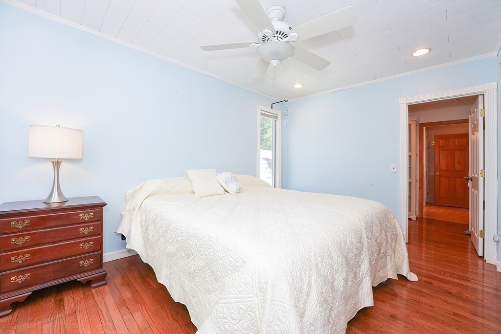 456 Gleasondale Road Stow, MA 01775 - Photo 12 of 30 a bedroom with a bed and a chandelier