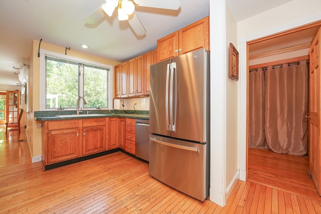 456 Gleasondale Road Stow, MA 01775 - Photo 13 of 30 a kitchen with stainless steel appliances granite countertop a refrigerator a sink and a large window