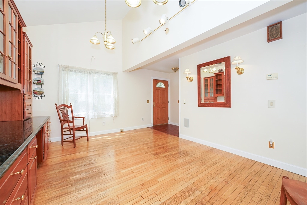 456 Gleasondale Road Stow, MA 01775 - Photo 14 of 30 a view of an empty room with a window and wooden floor