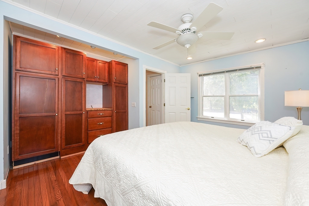 456 Gleasondale Road Stow, MA 01775 - Photo 15 of 30 a bedroom with a large bed window and a chandelier