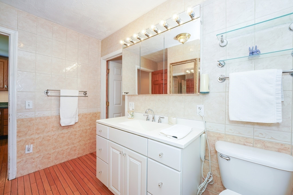 456 Gleasondale Road Stow, MA 01775 - Photo 16 of 30 a bathroom with a sink a toilet a mirror and vanity