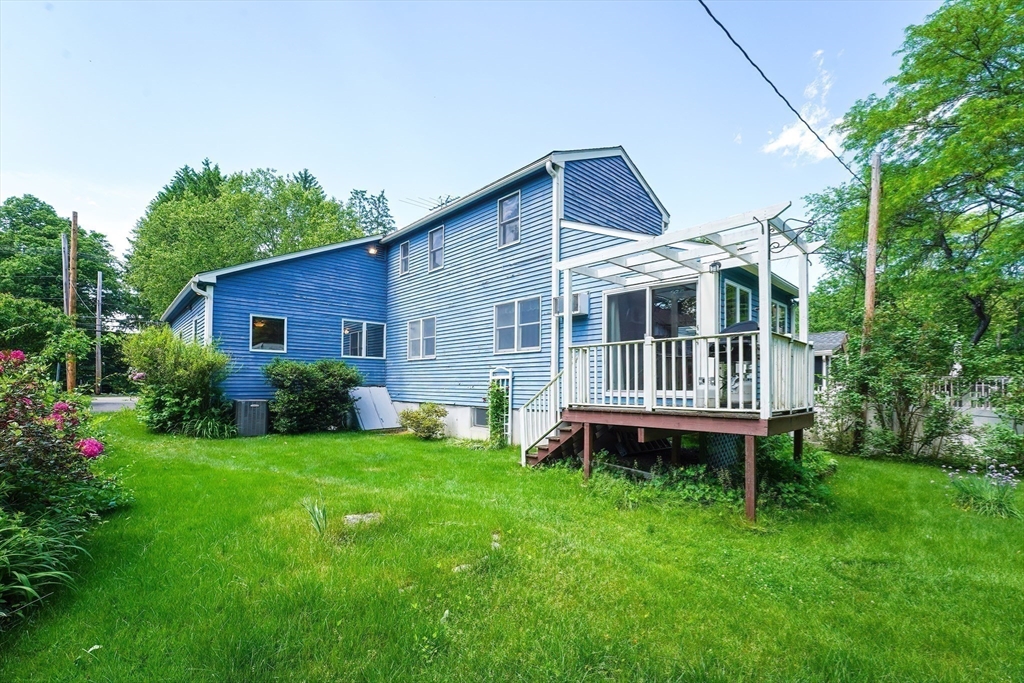 456 Gleasondale Road Stow, MA 01775 - Photo 2 of 30 a backyard of a house with a deck and garden