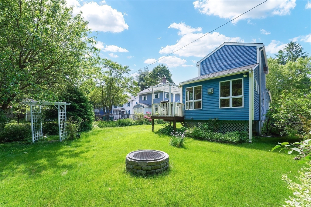456 Gleasondale Road Stow, MA 01775 - Photo 5 of 30 a backyard of a house with a yard and outdoor seating