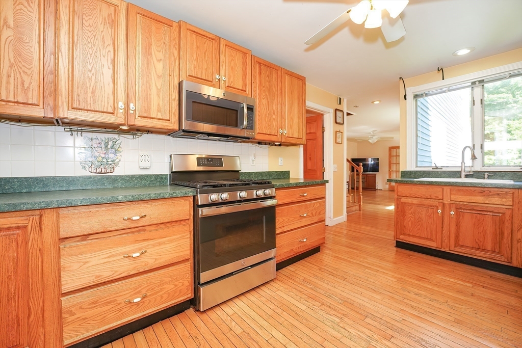 456 Gleasondale Road Stow, MA 01775 - Photo 8 of 30 a kitchen with stainless steel appliances granite countertop a stove a sink and a microwave