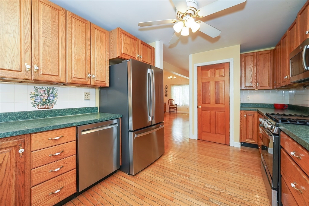 456 Gleasondale Road Stow, MA 01775 - Photo 10 of 30 a kitchen with granite countertop a refrigerator stove top oven and cabinets