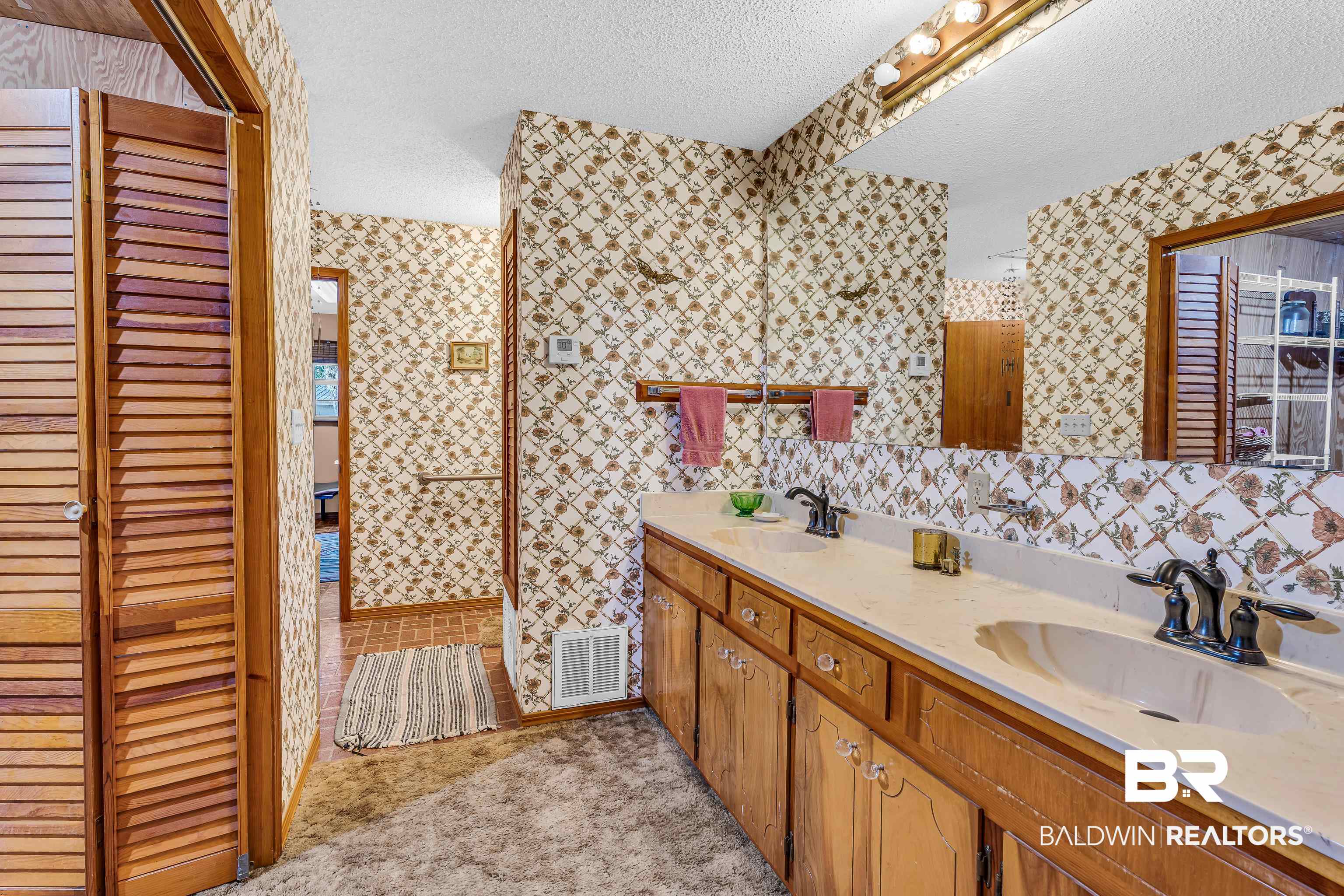 72075 Highway 59 Little River, AL 36550 - Photo 18 of 40 Full bathroom featuring a textured ceiling, double vanity, a closet, and wallpapered walls