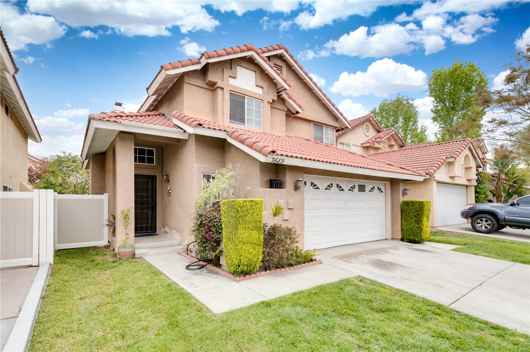 3689 Snowdrift Drive Riverside, CA 92503 - Photo 1 of 1 a front view of a house with a garden and garage