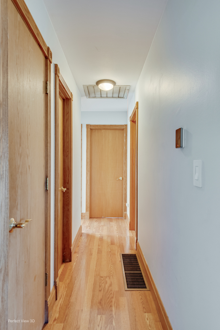 216 Kosan Circle Streamwood, IL 60107 - Photo 21 of 34 a view of a hallway with wooden floor