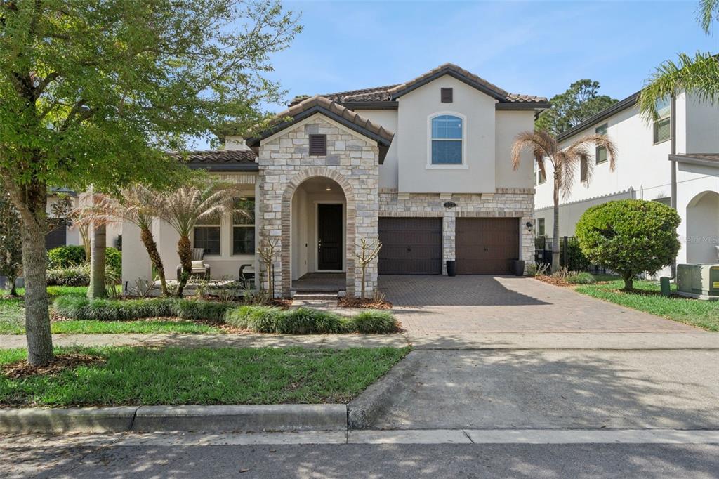 a front view of a house with a yard and garage