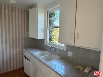 a kitchen with stainless steel appliances granite countertop a sink and a granite counter tops