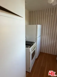 a kitchen with a stove and a refrigerator