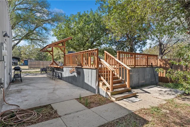 a view of a house with wooden fence