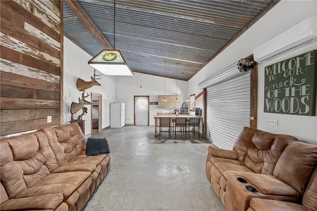 a view of a livingroom with furniture and white walls