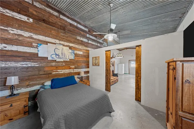 a bedroom with a large bed and a chandelier