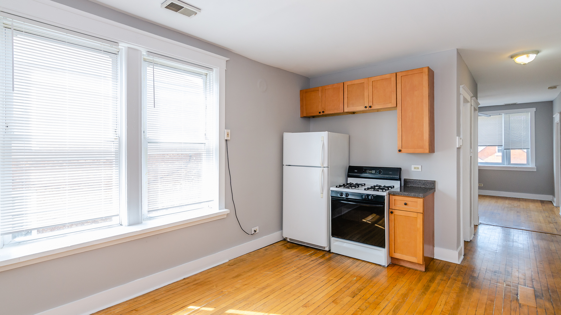 2639 West 25th Street, Unit 2F Chicago, IL 60608 - Photo 3 of 11 a kitchen with stainless steel appliances granite countertop a stove a refrigerator and a window
