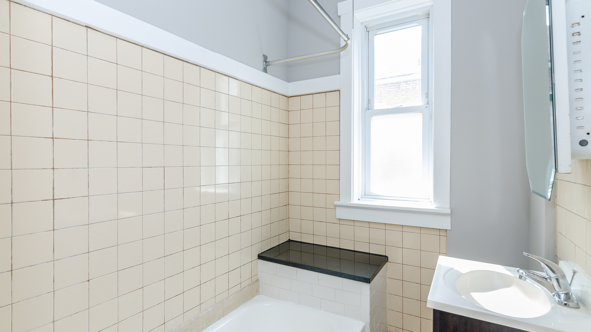 2639 West 25th Street, Unit 2F Chicago, IL 60608 - Photo 10 of 11 a bathroom with a sink a toilet and window
