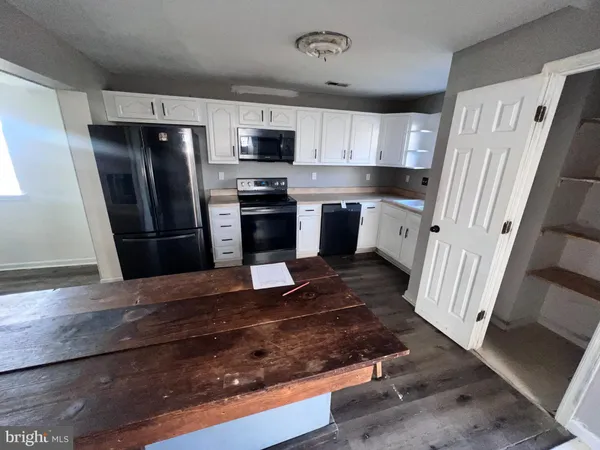 a kitchen with stainless steel appliances granite countertop a refrigerator stove and sink