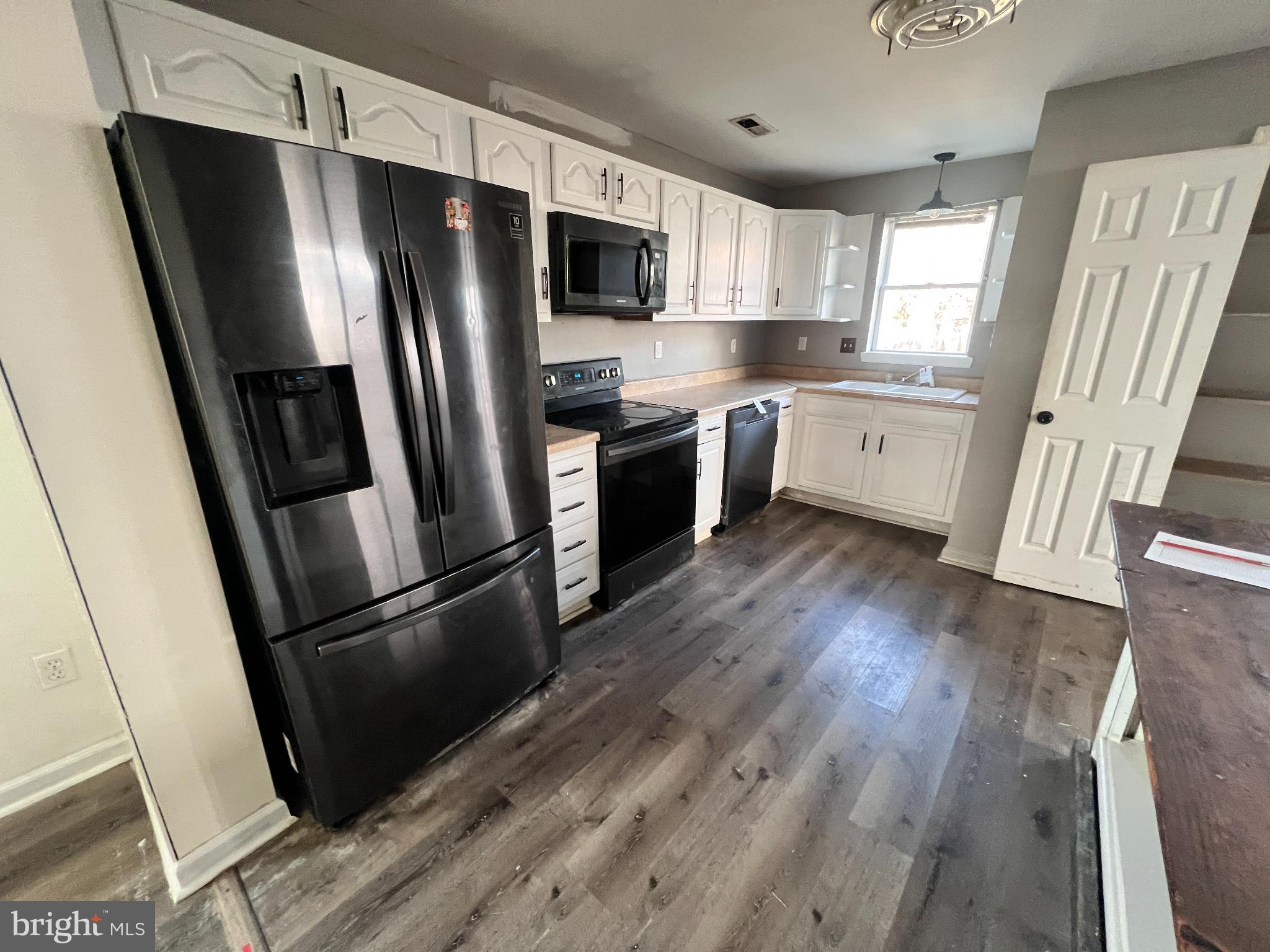 104 West High Street Hancock, MD 21750 - Photo 6 of 28 Modern kitchen with sleek black appliances.