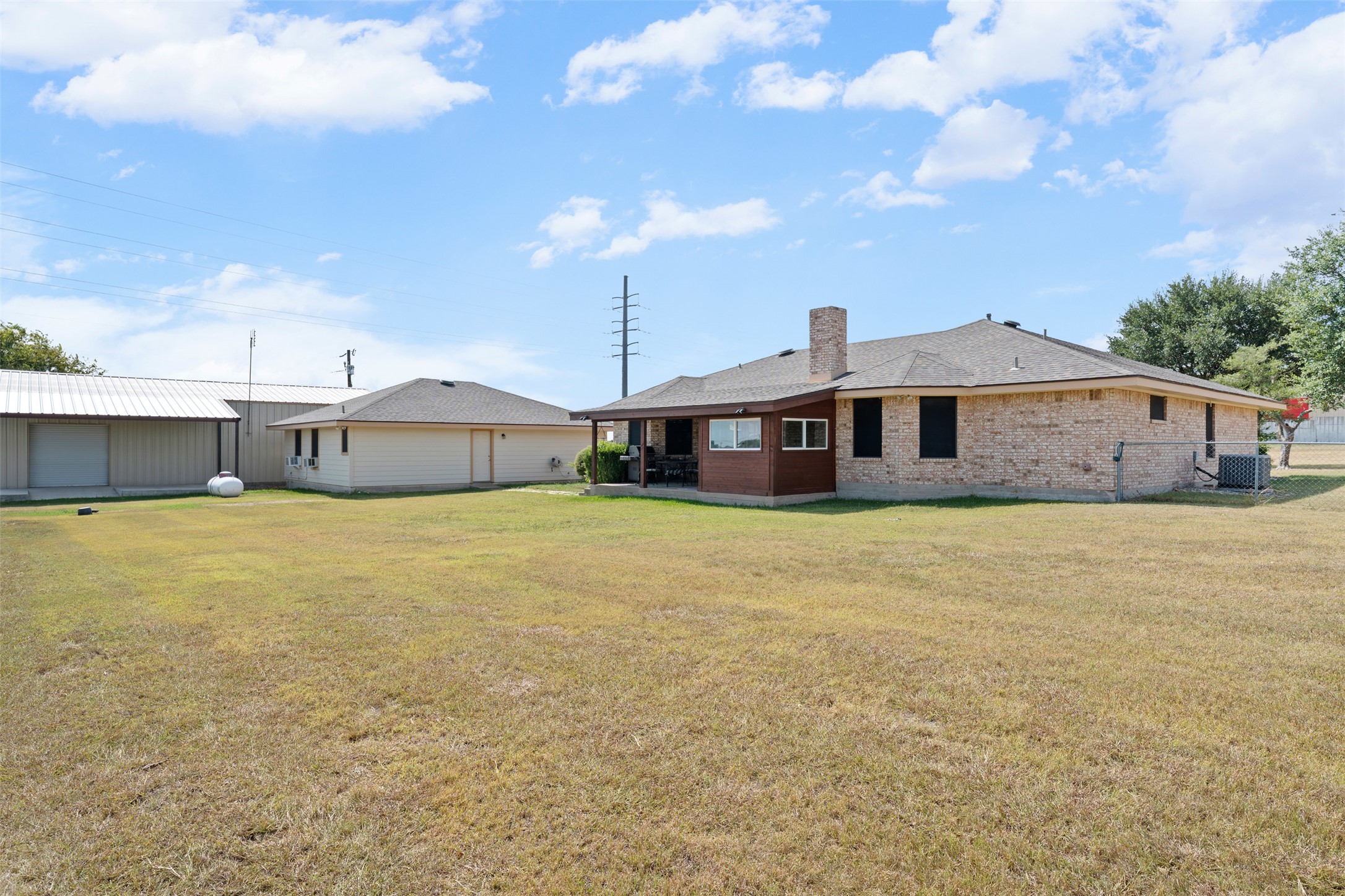 1512 Panther Loop Pflugerville, TX 78660 - Photo 33 of 40 A spacious backyard provides ample room for outdoor activities, complemented by a covered patio for relaxed entertaining.