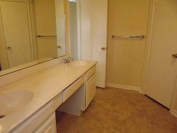 a bathroom with a granite countertop sink and a white cabinet