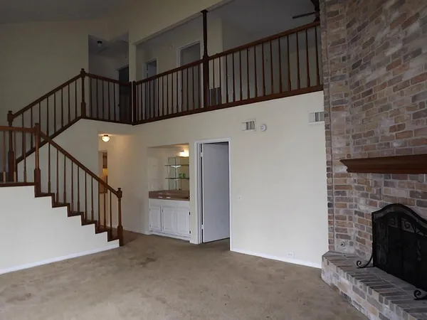 a view of staircase with fireplace