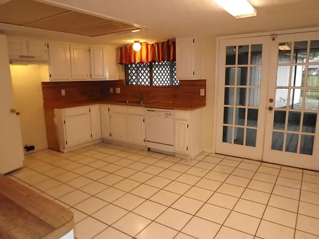 a kitchen with a sink and cabinets