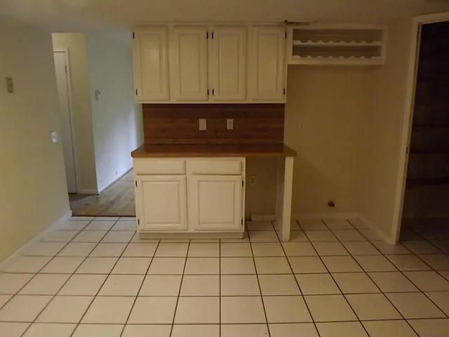 a kitchen with a white cabinets and a stove top oven