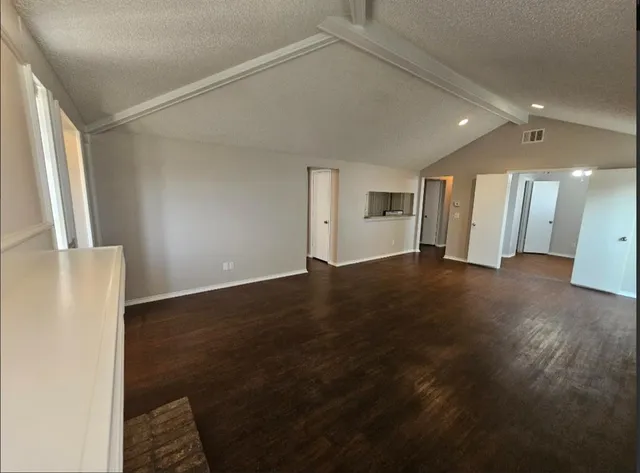 a view of a big room with wooden floor windows and stairs