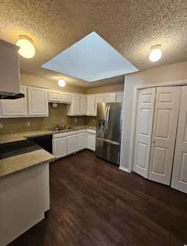 a kitchen with stainless steel appliances granite countertop a sink and stove