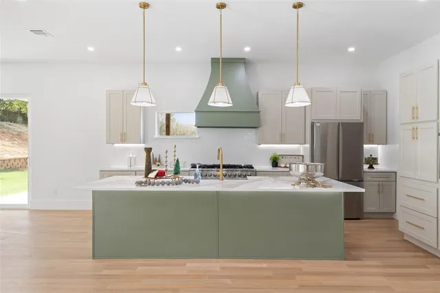 a large kitchen with stainless steel appliances kitchen island a large island in the center