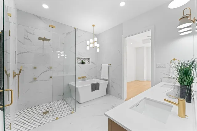 a spacious bathroom with a tub shower and windows