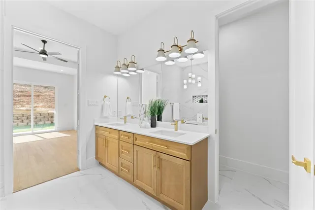 a spacious bathroom with a double vanity sink mirror and next to a window
