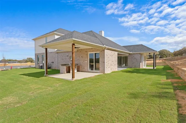 a view of a house with a yard and a garden