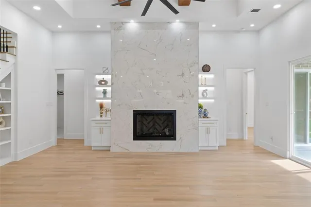 an empty room with fireplace and windows