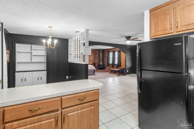 a view of a kitchen with a refrigerator and a sink