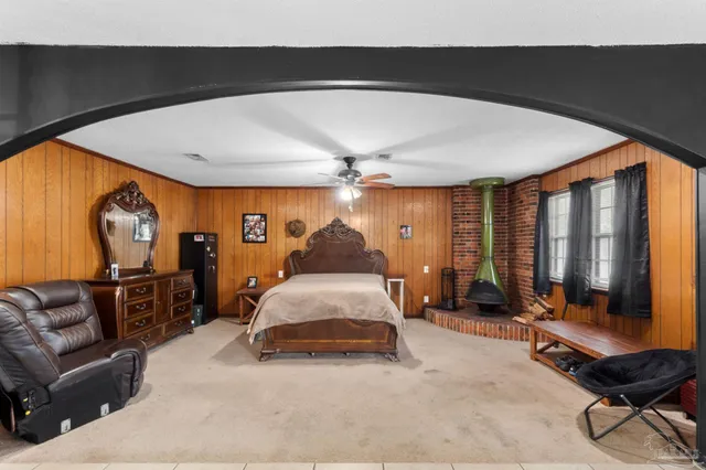 a bed room with a bed and a chair