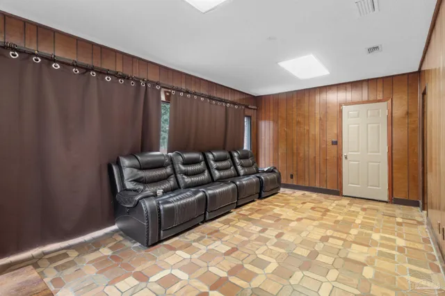 a large bedroom with a bed and a chair