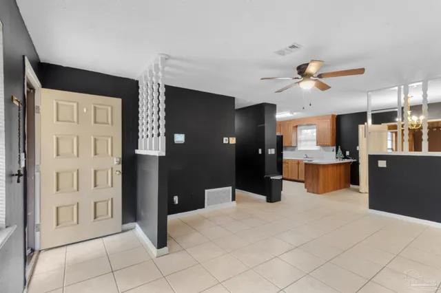 a kitchen view of a refrigerator and a chandelier