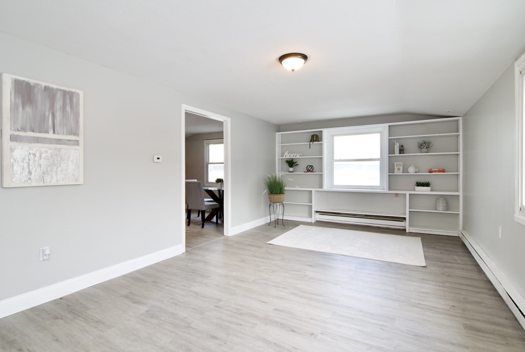160 Laurelton Street Springfield, MA 01109 - Photo 3 of 30 a view of a livingroom with wooden floor and a cabinet