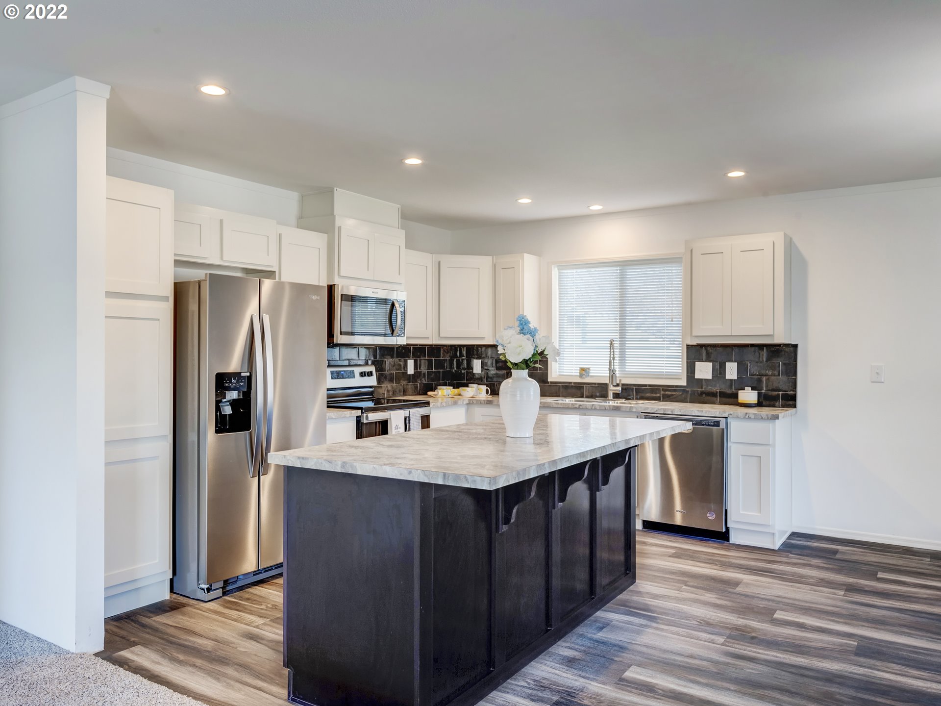4671 Union Terrace Springfield, OR 97478 - Photo 8 of 18 a kitchen with kitchen island a sink stainless steel appliances and refrigerator