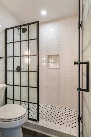 a bathroom with a toilet and a shower