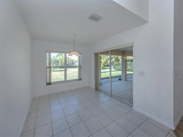 a view of a hallway with entryway and wooden floors