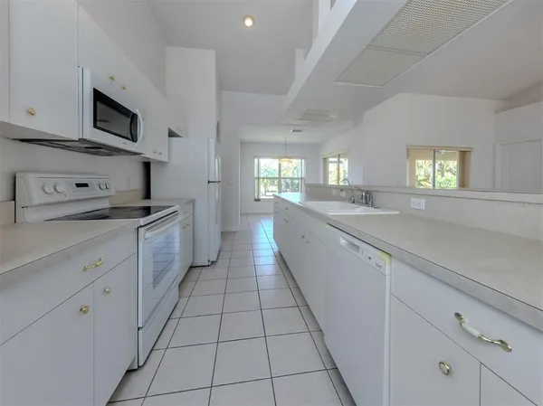 a kitchen with stainless steel appliances granite countertop a sink and a stove