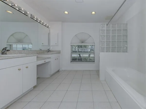 a utility room with cabinets washer and dryer