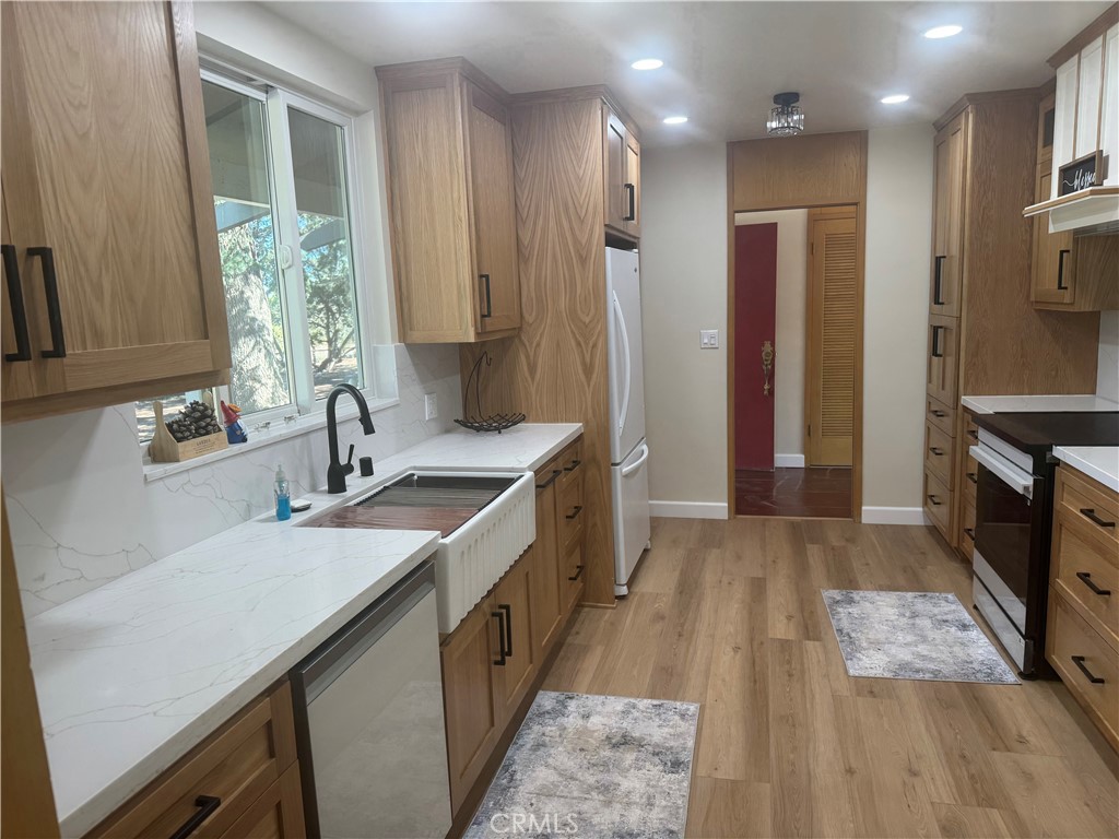 a kitchen with a sink stove and refrigerator