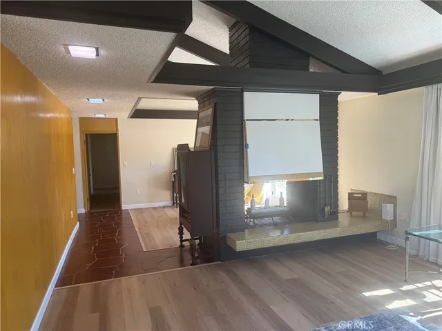a view of a room with furniture wooden floor and chandelier
